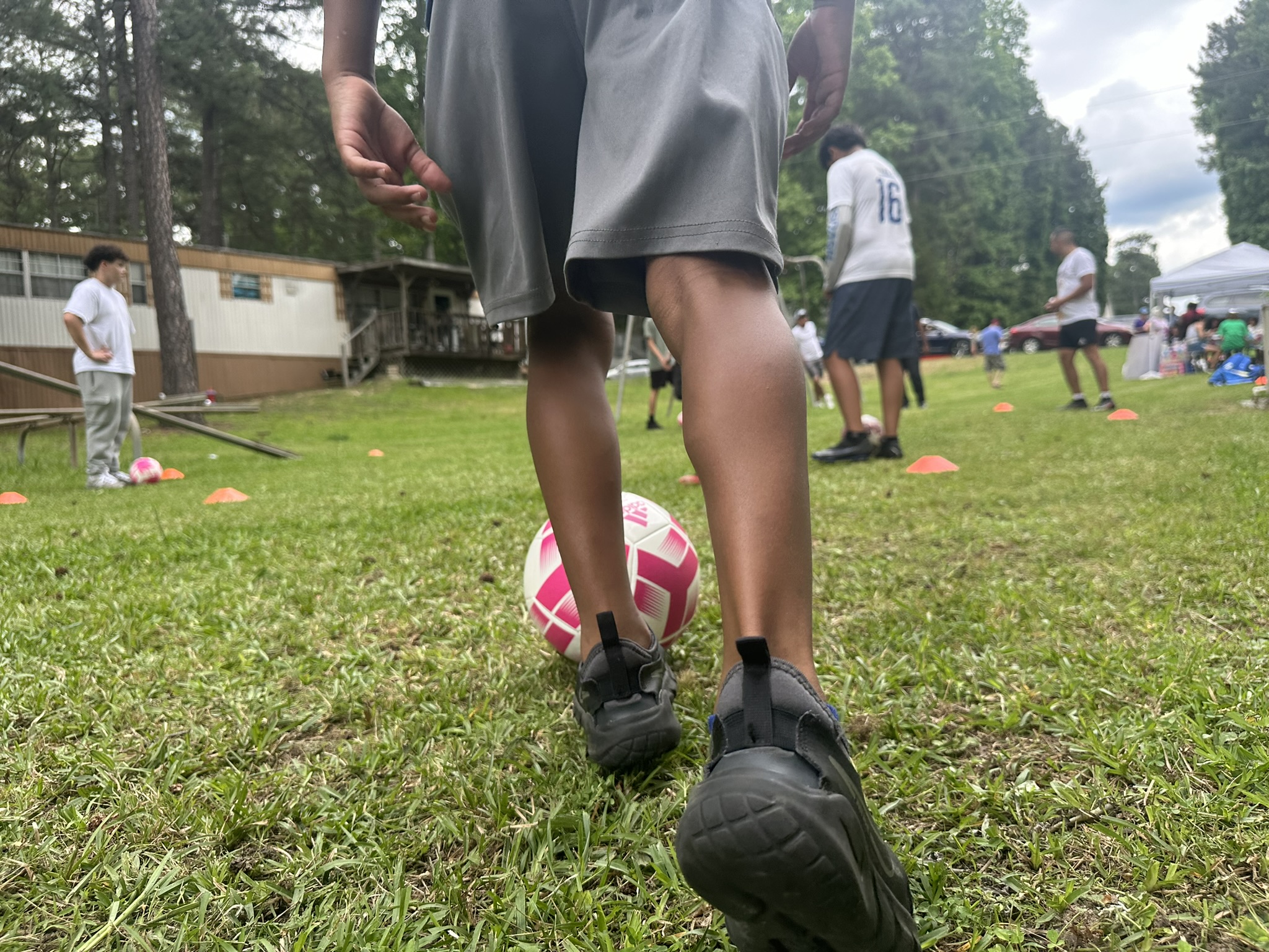 child kicking a soccer ball